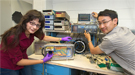 Design Engineer Justine Haupt (left) and Postdoctoral Research Associate Dajun Huang (right) prepare a test chamber.