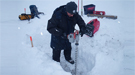 Alex Kholodov (University of Alaska, Fairbanks) uses an electric auger to prepare holes for water wells at NGEE Arctic Sites in Barrow, Alaska.
