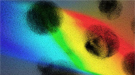 In this artist’s rendering, ultraviolet light is converted by nanoparticles (black dots) into visible light.