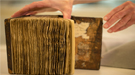 Conservators at Stanford University Libraries removed the pages from the leather-bound cover of the book of hymns, and mounted each leaf in an individually fitted, archival mat. 