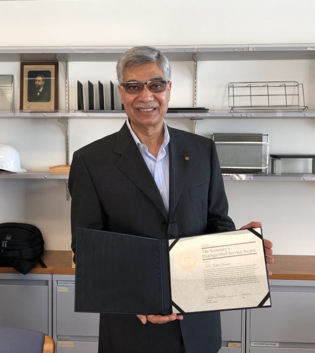 Zahid Hussain holds his DOE Secretary’s Distinguished Service Award certificate. (Credit: Berkeley Lab)