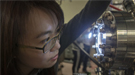 Co-lead author Chiu-Yun Lin peers into  a viewing port of the SARPES detector.