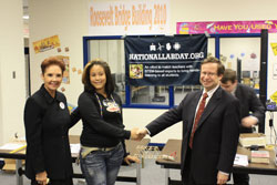 Dr. Koonin shakes hands with a Roosevelt High School student