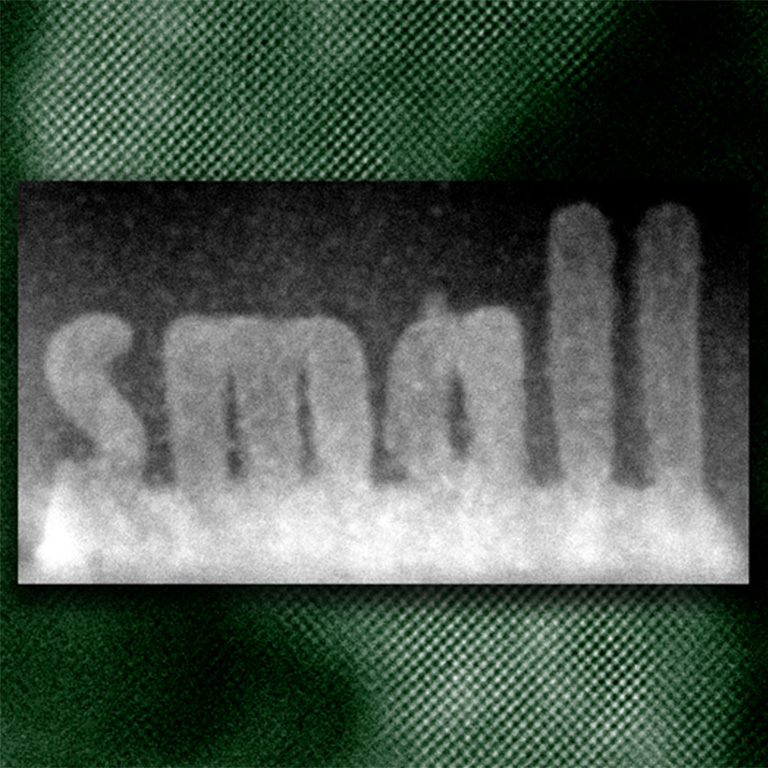 The crystallized oxide (lighter regions) spelling the word “small” was “printed” on a non-crystallized layer (darker gray) by a well-controlled beam in an electron microscope.