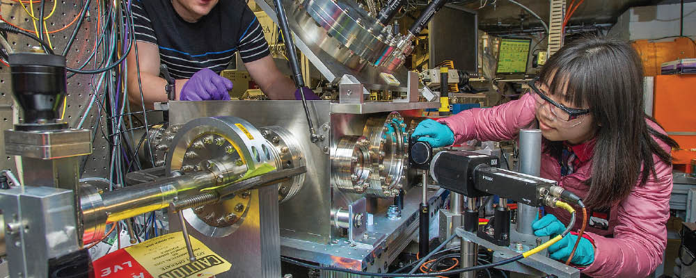 Users setting up their experimental apparatus for research involving terahertz radiation and dielectric structures.